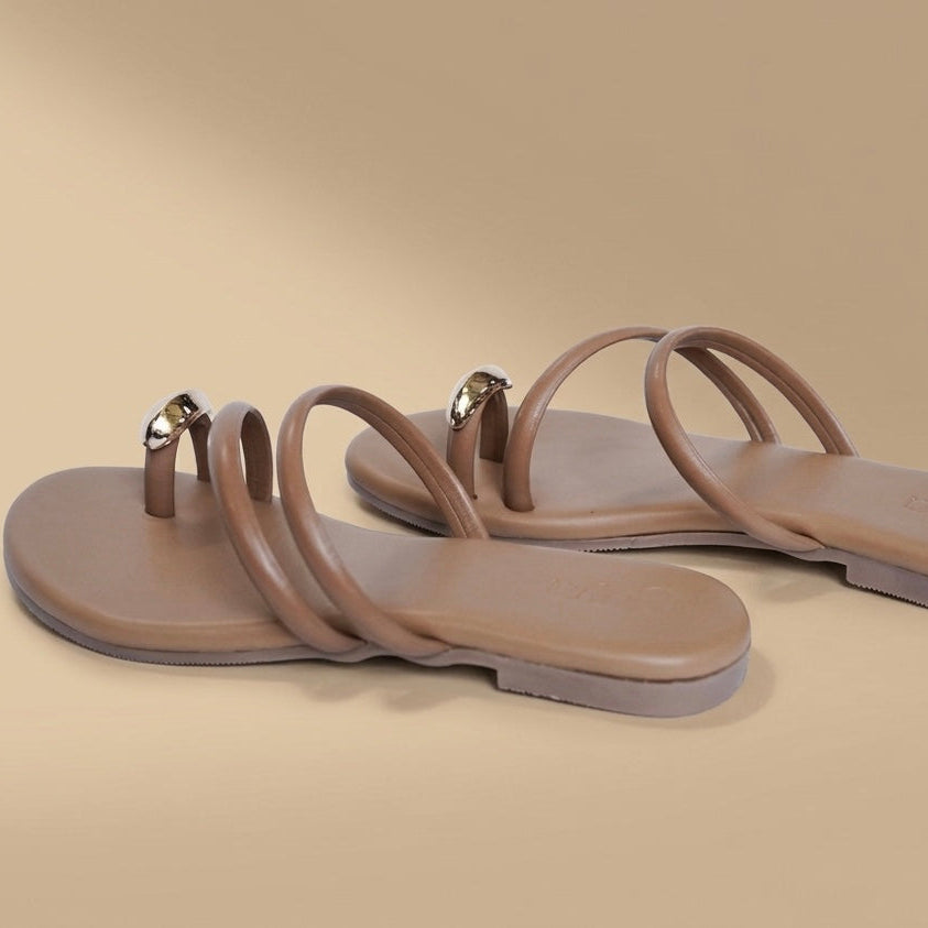 Pair of beige sandals on a beige background